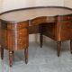 Regency style hardwood and leather kidney desk with gallery.