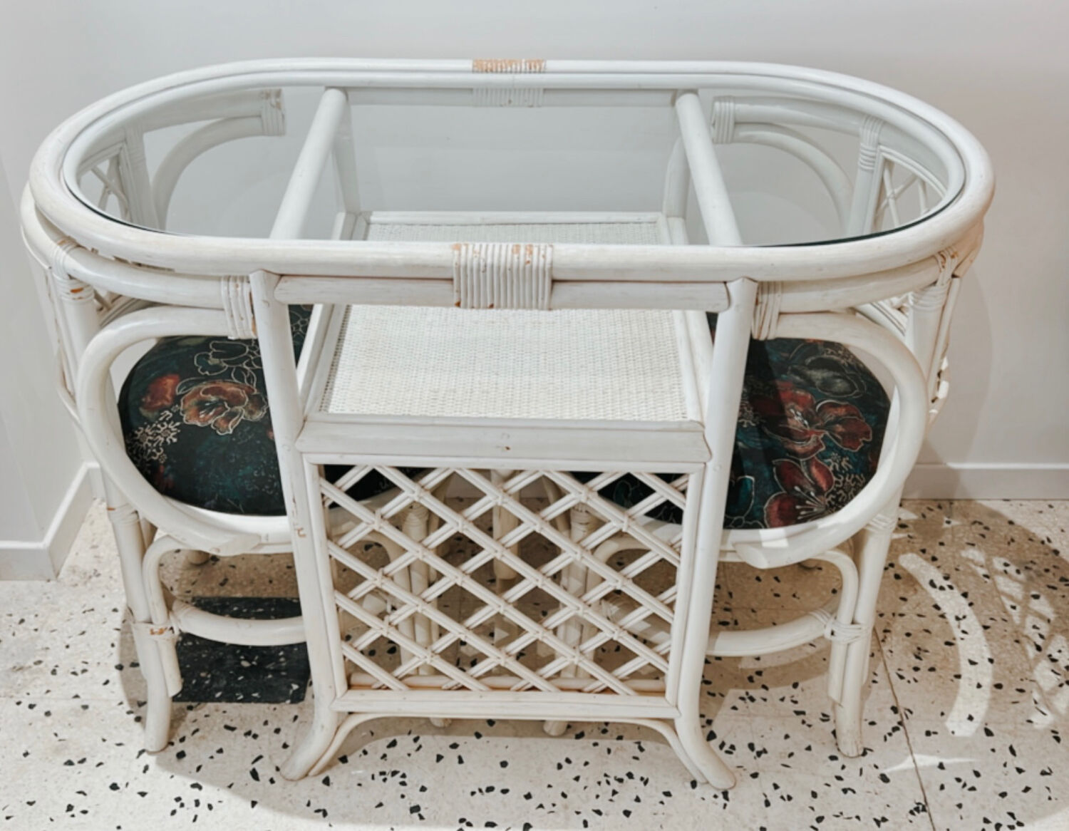 Rattan head-to-head table with vintage armchairs