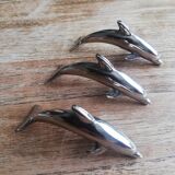 Set of three silver metal dolphin place markers