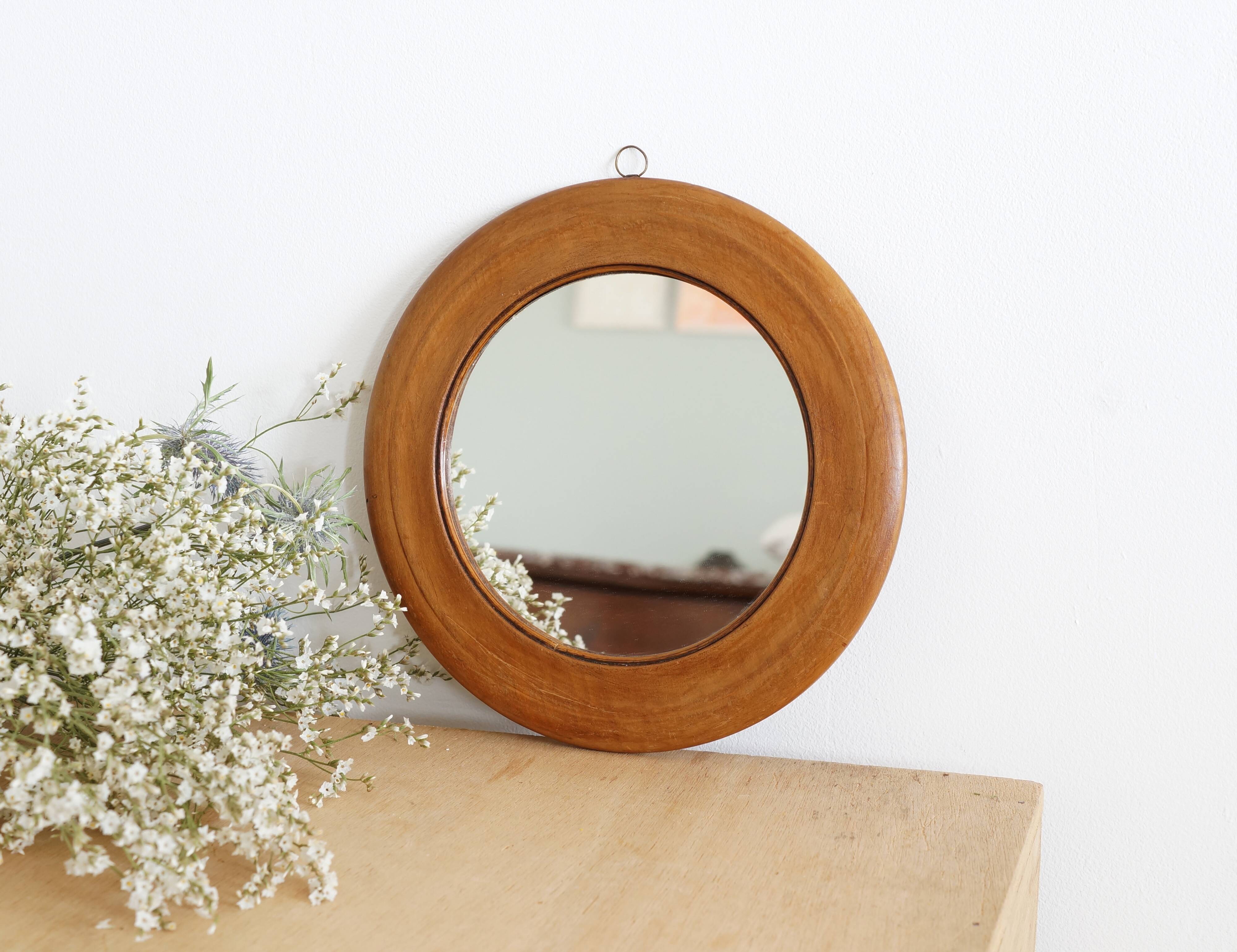 Antique round mirror with turned wooden frame