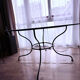 Round dining table in glass and wrought iron.