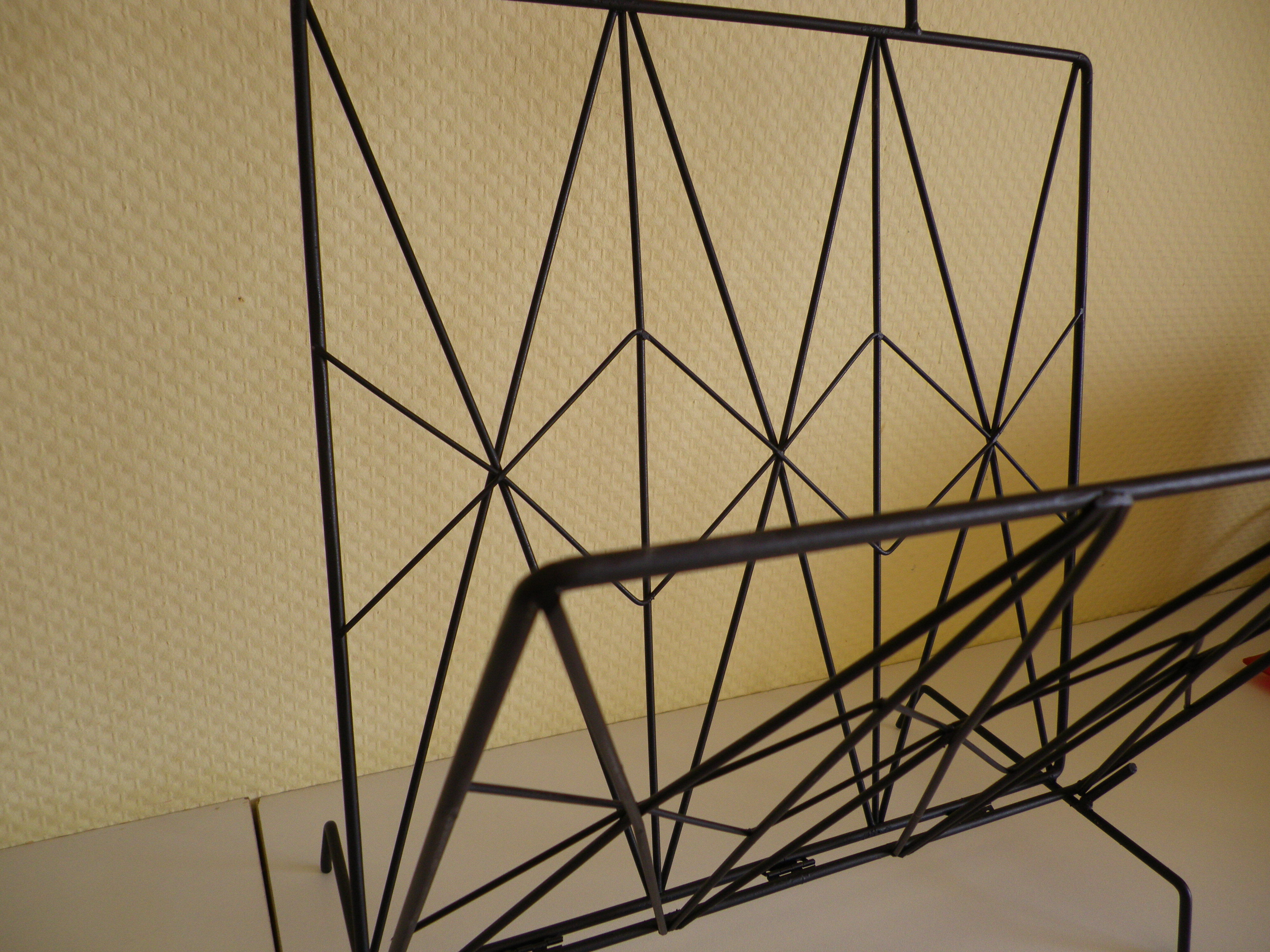 Magazines rack with very fine black metal geometric