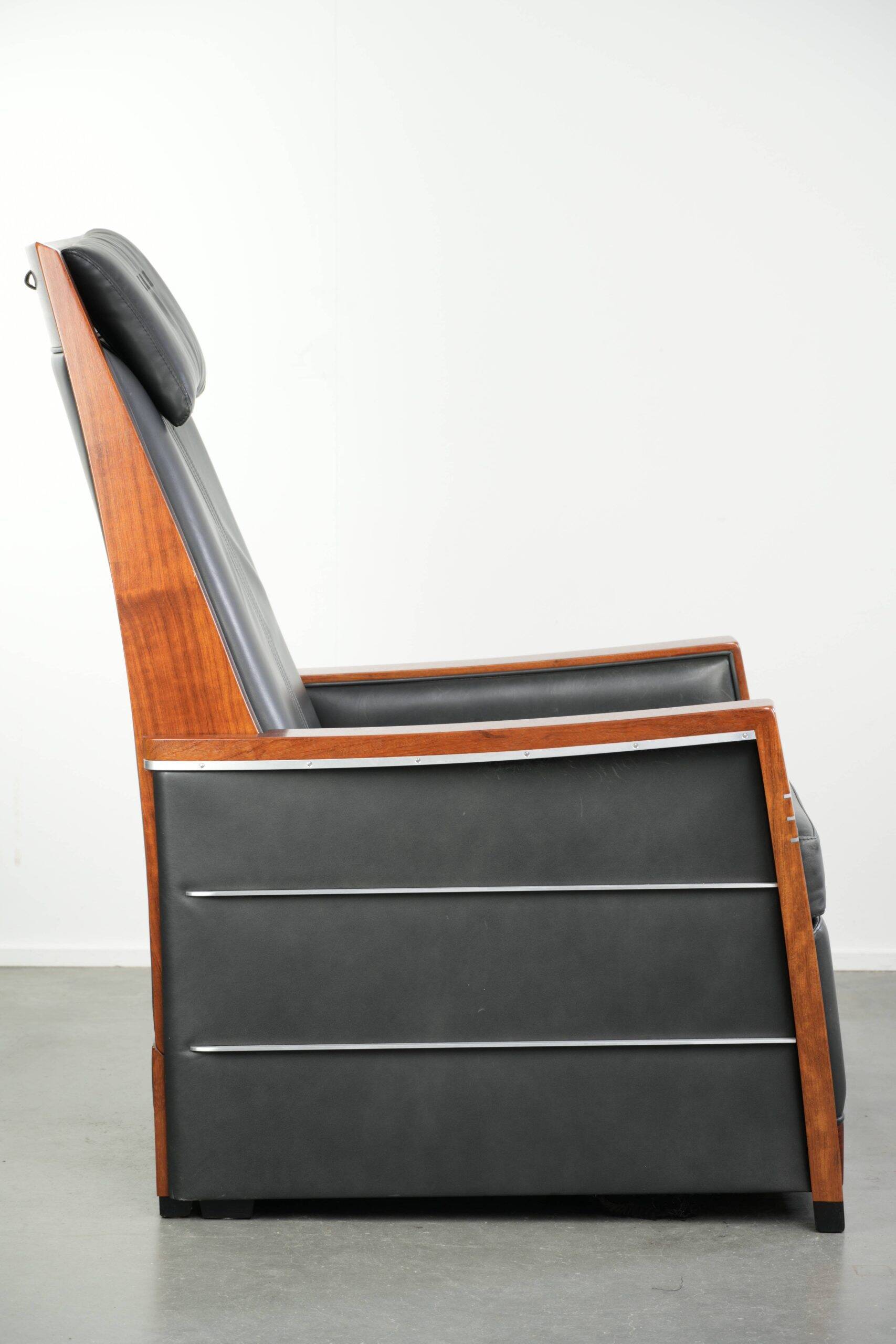 Electrically adjustable Art Deco design recliner with black cowhide leather
