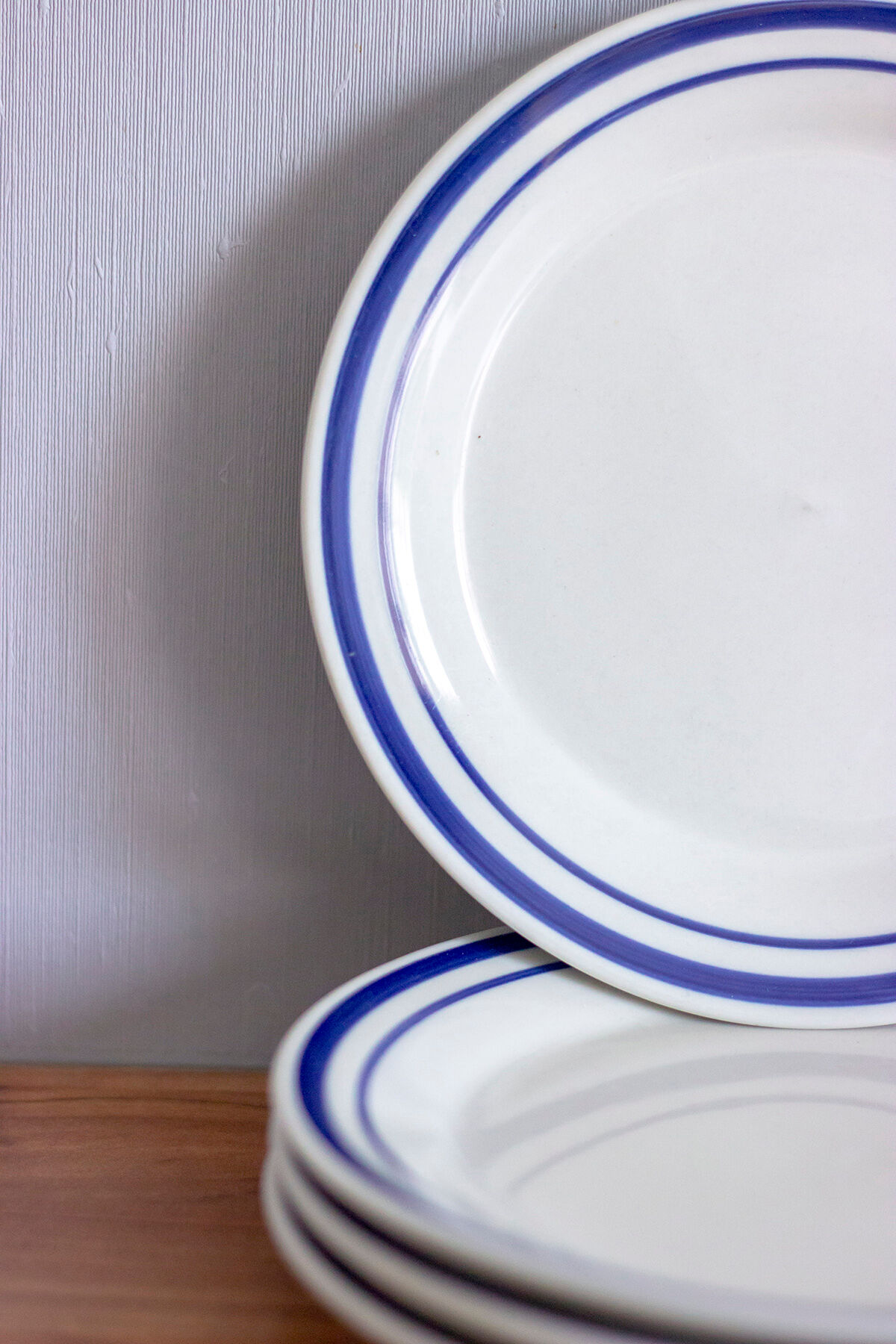 4 blue bordered dessert plates and a matching bowl