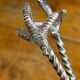 Sugar tongs or ice tongs in silver-plated metal.