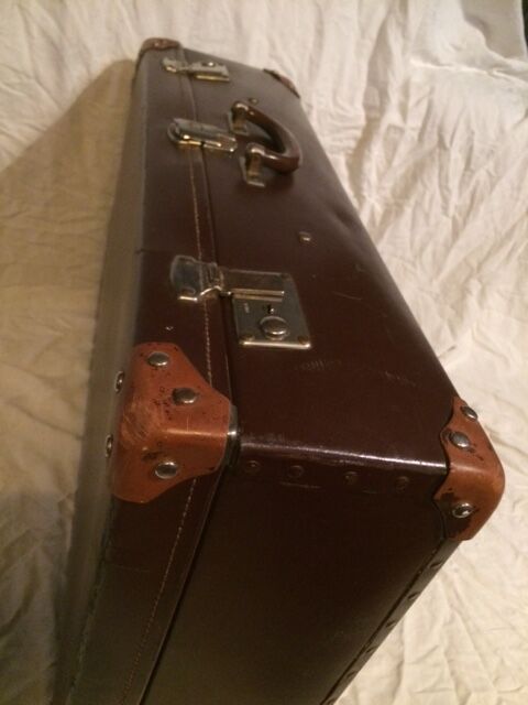 Suitcase vintage leather inside and brown carpeted home