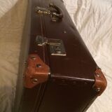 Suitcase vintage leather inside and brown carpeted home