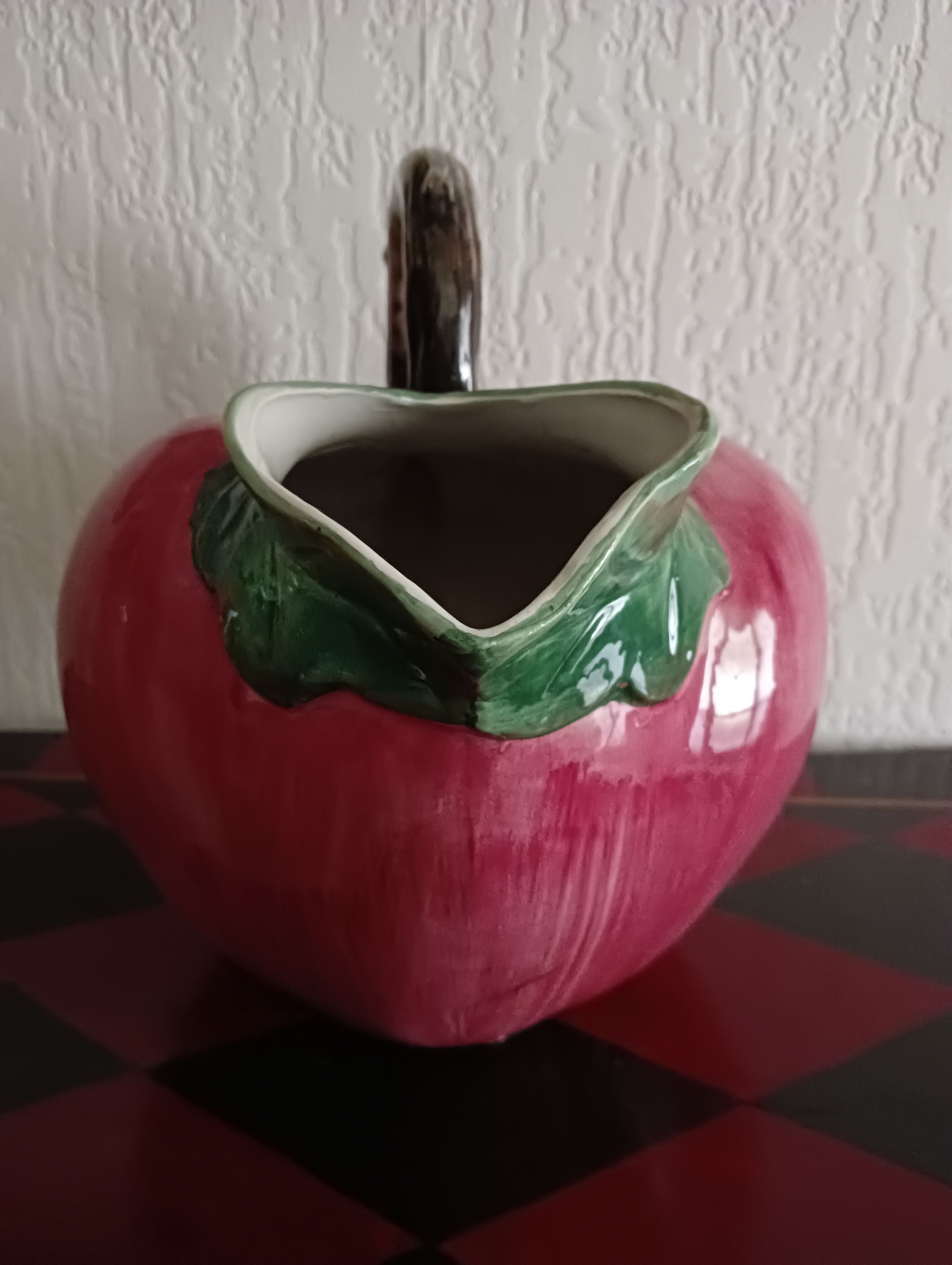 Pink pitcher in the shape of a strawberry, Italian slurry.