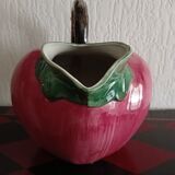 Pink pitcher in the shape of a strawberry, Italian slurry.