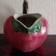 Pink pitcher in the shape of a strawberry, Italian slurry.