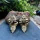 Pair of bronze wall sconces with mask, signed L. Pinet, Art Nouveau period.