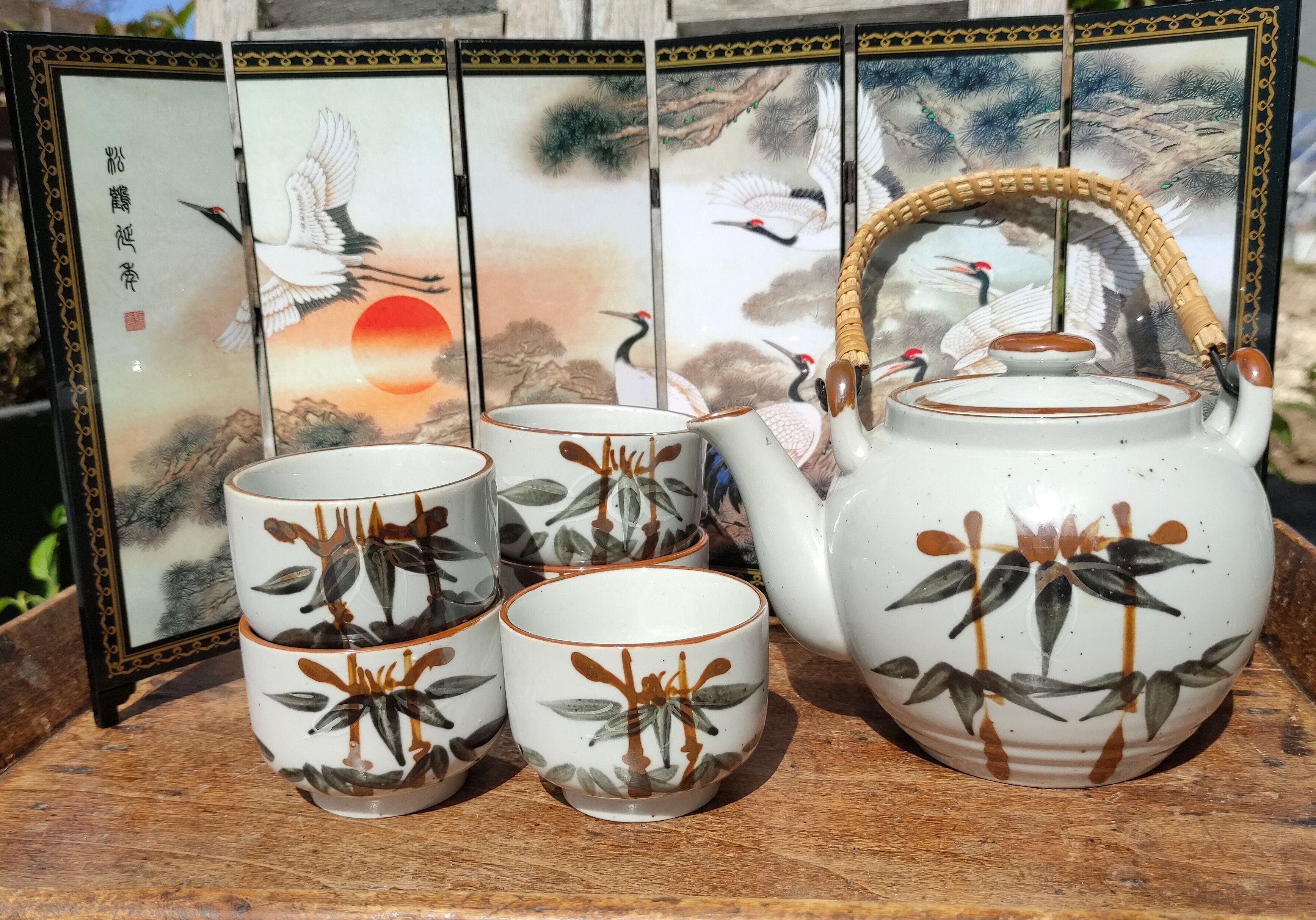 Asian set of a teapot and its cups