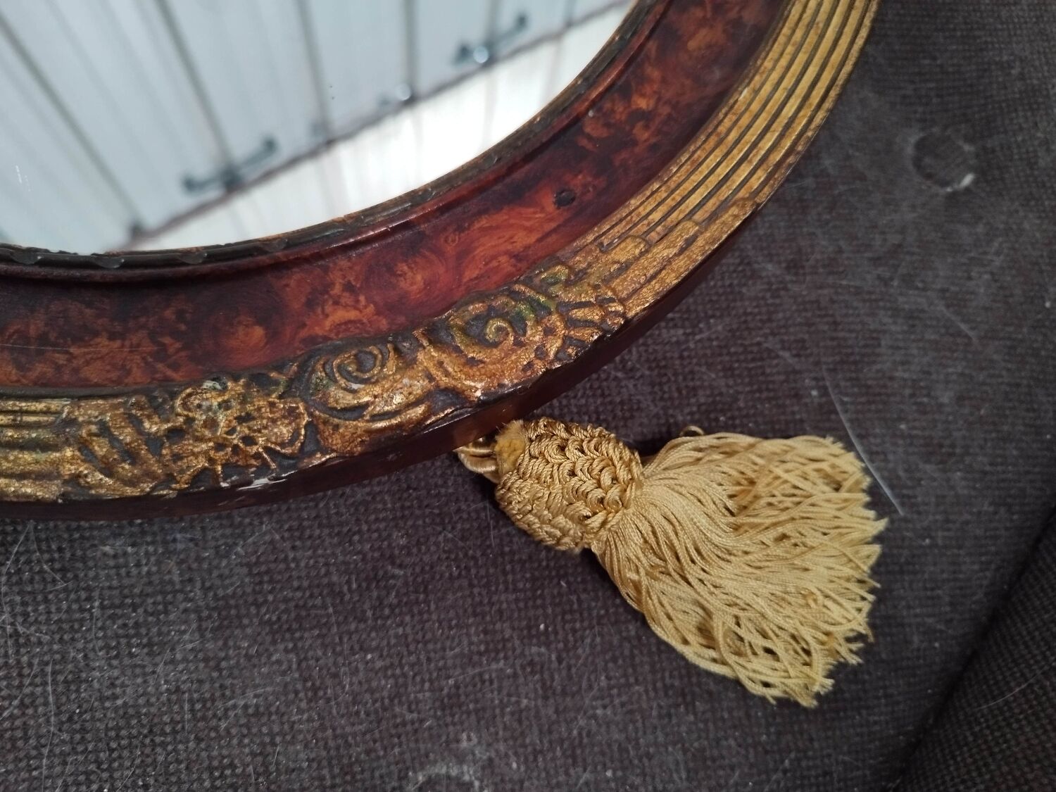 Golden oval art deco mirror