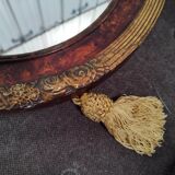 Golden oval art deco mirror