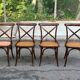 4 bistro chairs with curved wooden backs and cross braces / Crossback