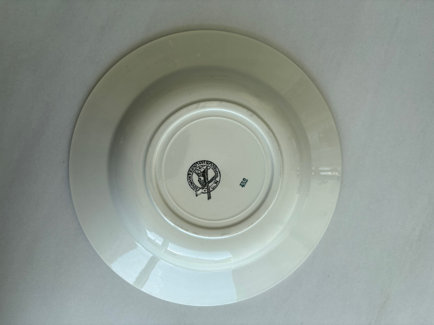 A deep plate in blue and green ironstone, antique French earthenware.