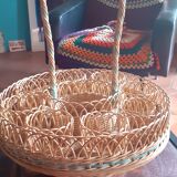 Glass holder and wicker bottle with green plastic water surface