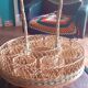Glass holder and wicker bottle with green plastic water surface