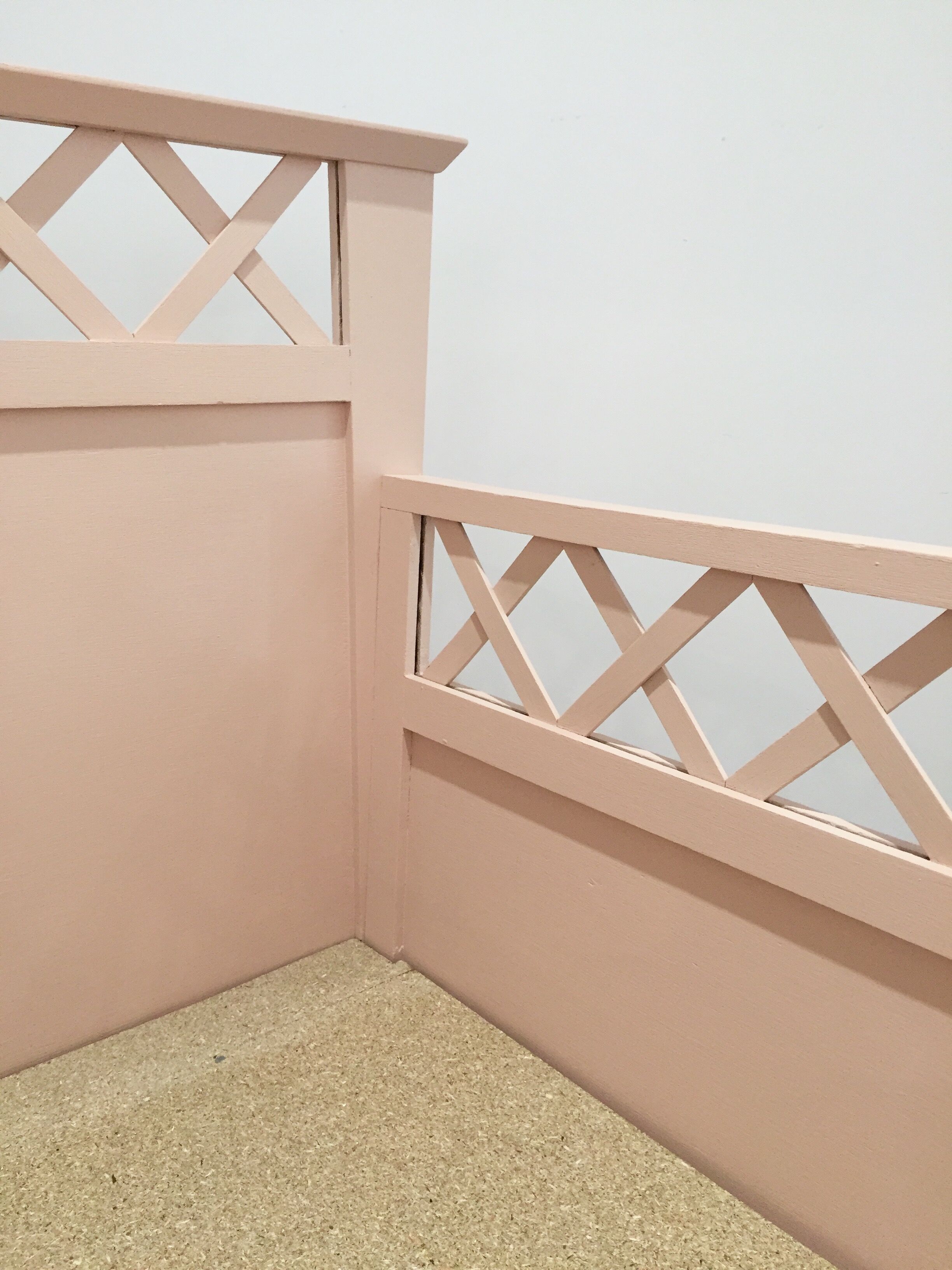 Vintage wooden baby bed in old pink