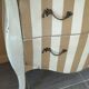 Curved commode with beige and white stripes.