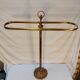 Old golden brass towel rack on baroque style foot