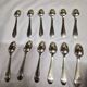 12 silver-plated metal teaspoons with a hallmark of 18.