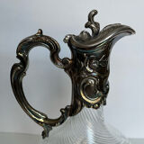 Glass decanter and silver metal frame