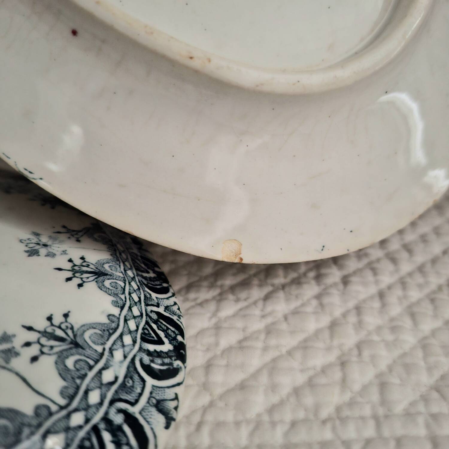 Antique iron earthenware sauceboat on a frame