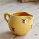 Vintage yellow ceramic milk jug