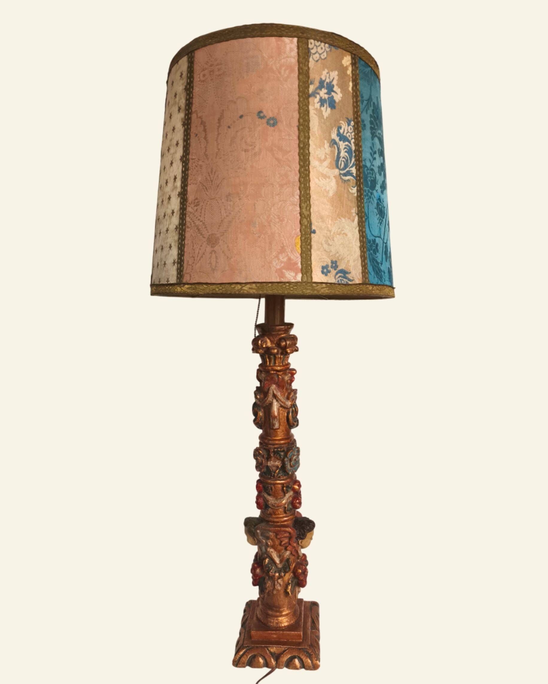 Renaissance table lamp in polychrome carved wood with cherubs.