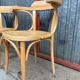 Pair of curved wooden bistro chairs with armrests