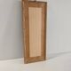 Vintage frame with palm tree and sun in wood or wicker.
