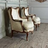 Pair of small Louis XV style wing chairs in carved walnut, Bosson stamp