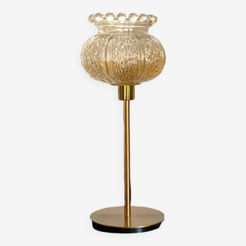 Table lamp with an old crowned globe and a golden foot