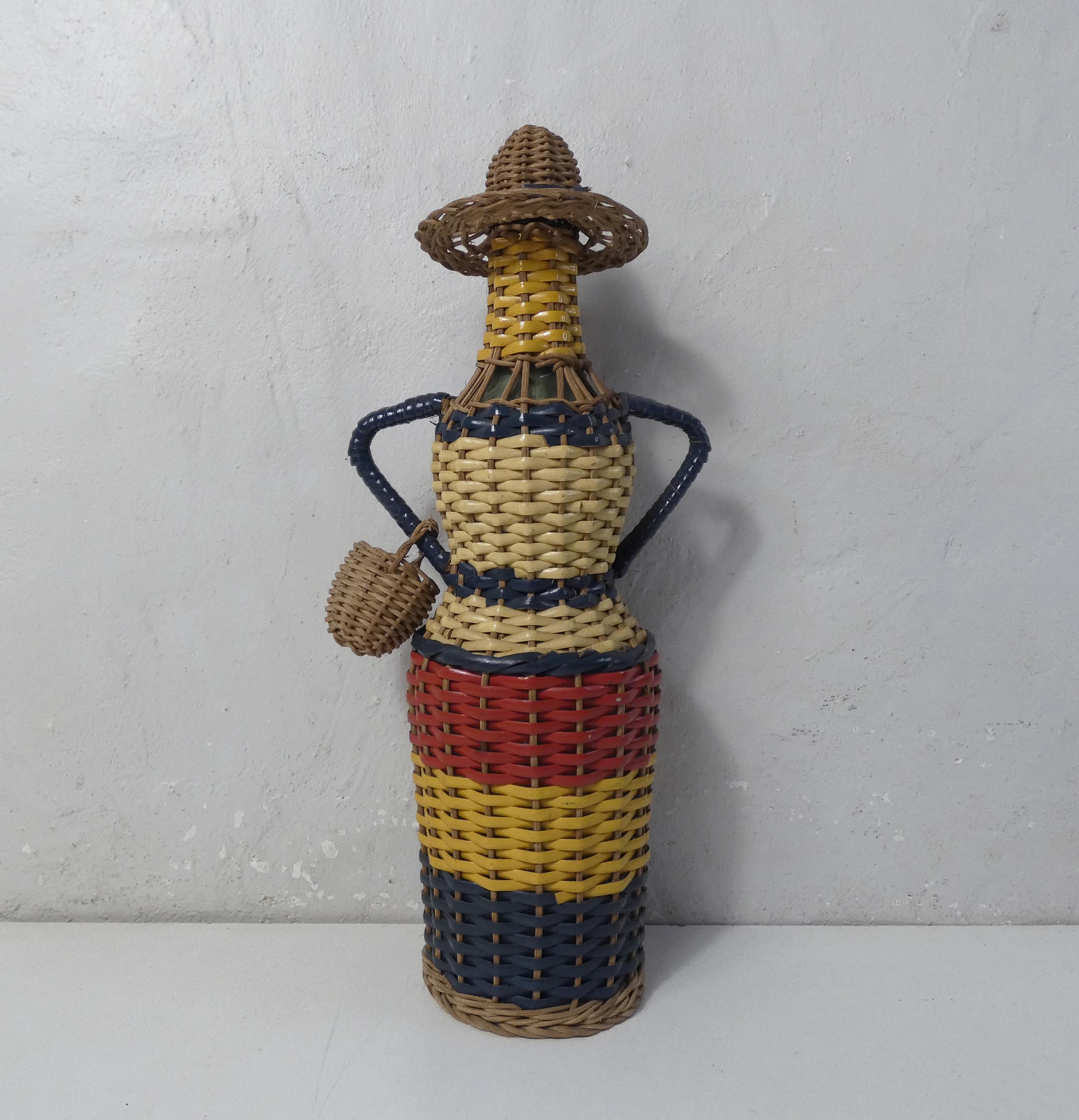 Old bottle dressed in scoubidou style rattan