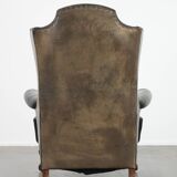 Antique black English cow leather wingback armchair from the 19th century