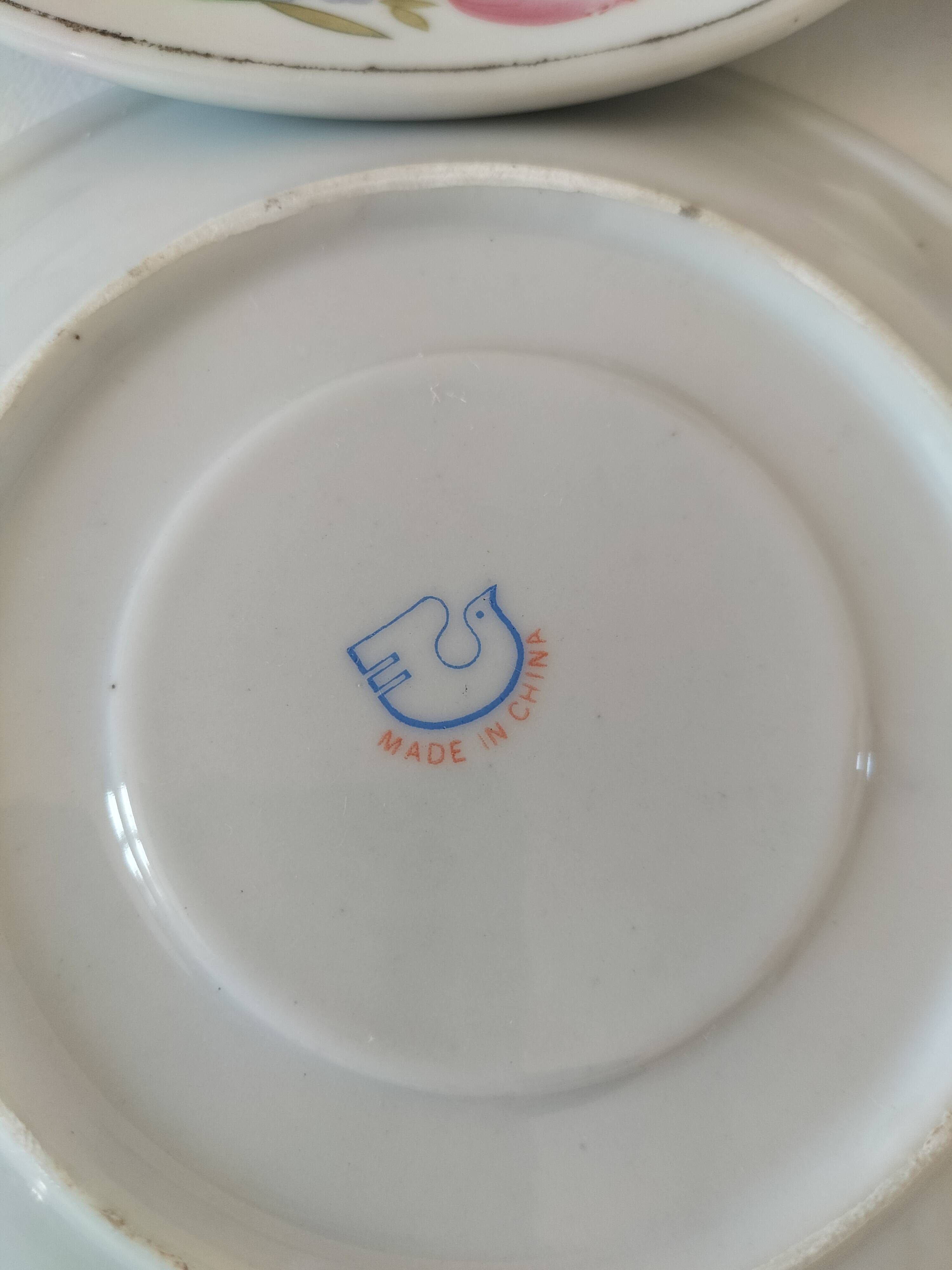 Trio of floral porcelain cups and saucers