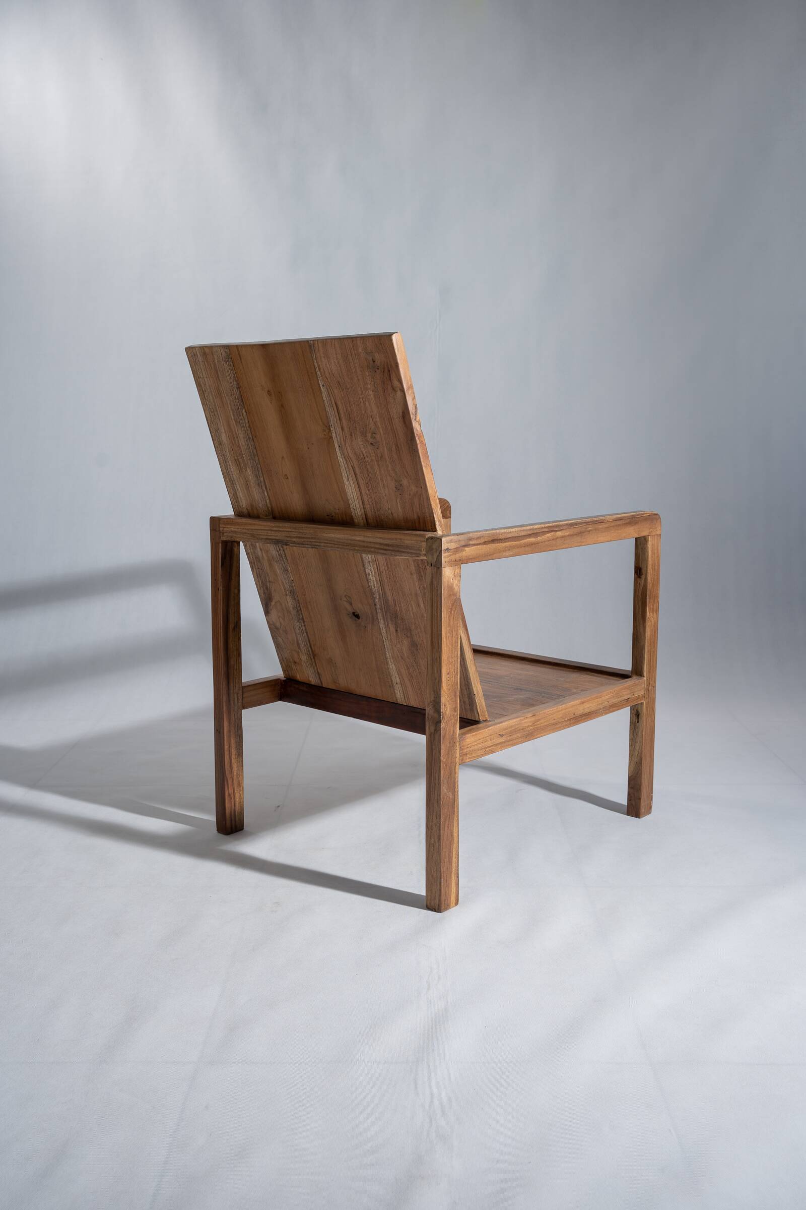 Large armchair in natural wood (teak) with a minimalist design.