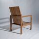 Large armchair in natural wood (teak) with a minimalist design.
