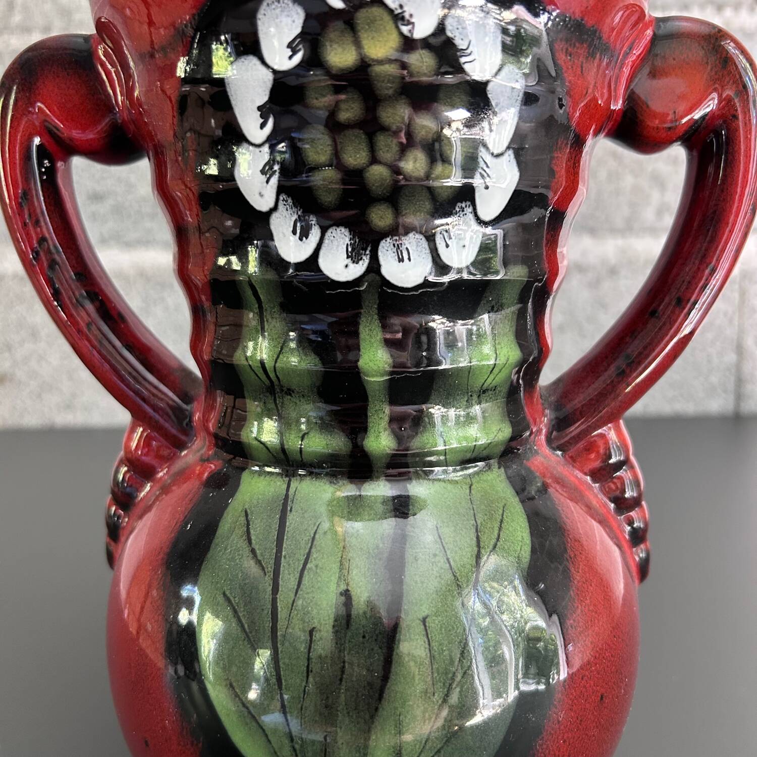 Red vase with floral decoration