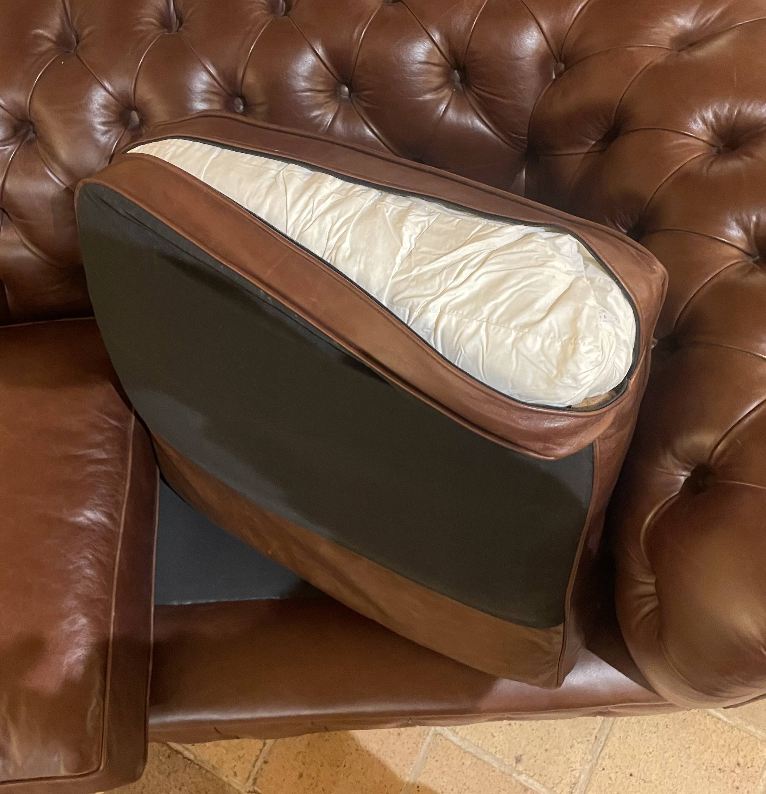 brown leather 2-seater Chesterfield sofa