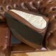 brown leather 2-seater Chesterfield sofa