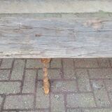 French country style cast iron bench with old rustic wooden plank