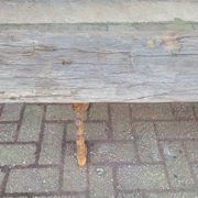 French country style cast iron bench with old rustic wooden plank
