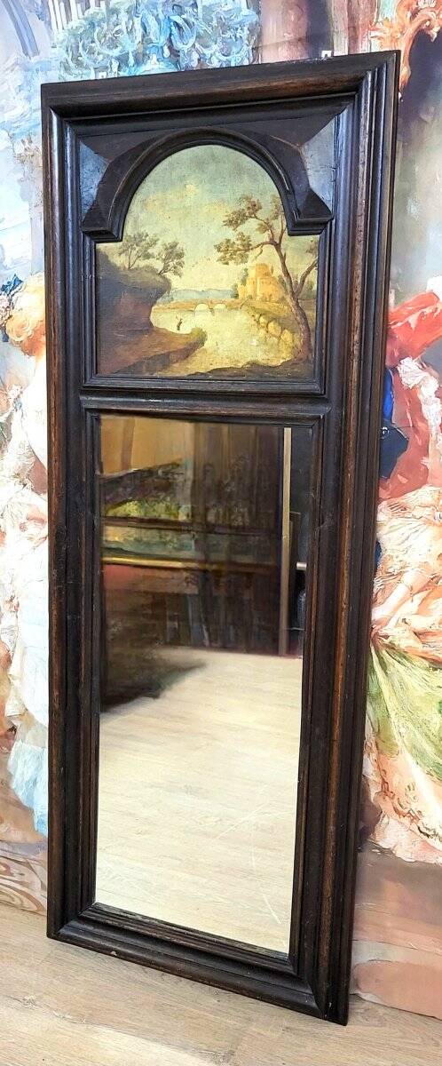 Dark wood trumeau with a mirror and landscape painting.