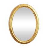 Golden oval mirror with leaf