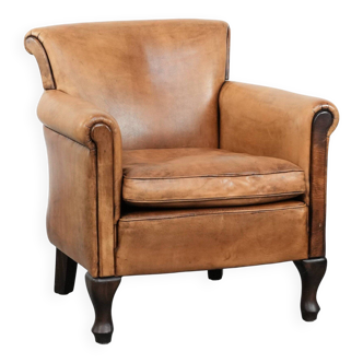 Vintage sheepskin armchair with a beautiful light colour and elegant legs