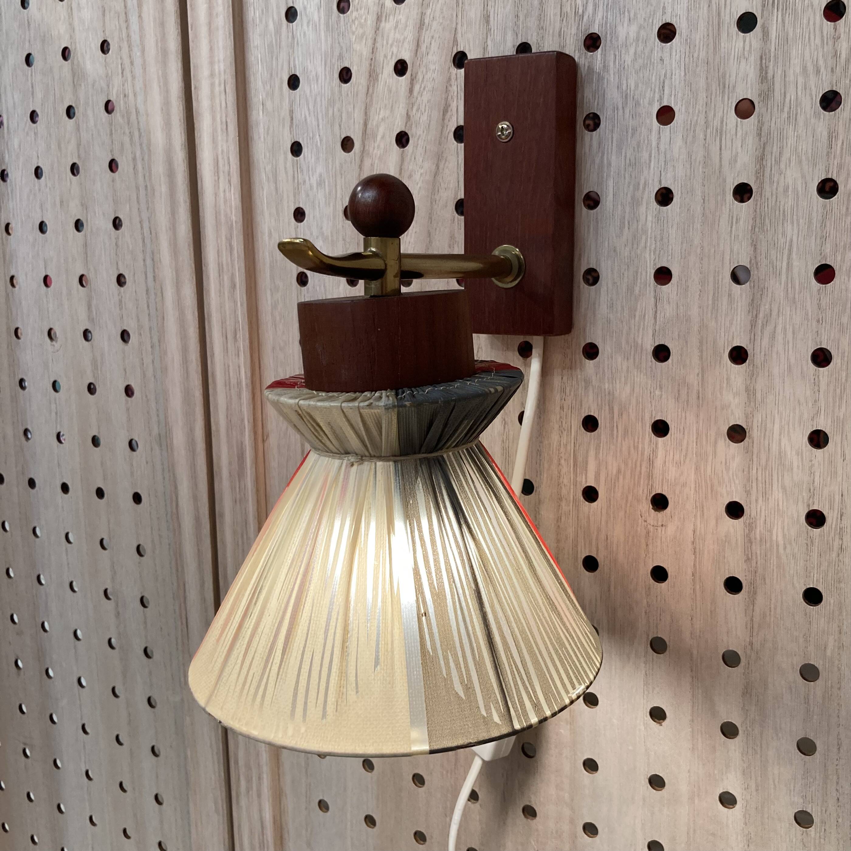 Scandinavian design wall light in teak and brass from the 1950s.