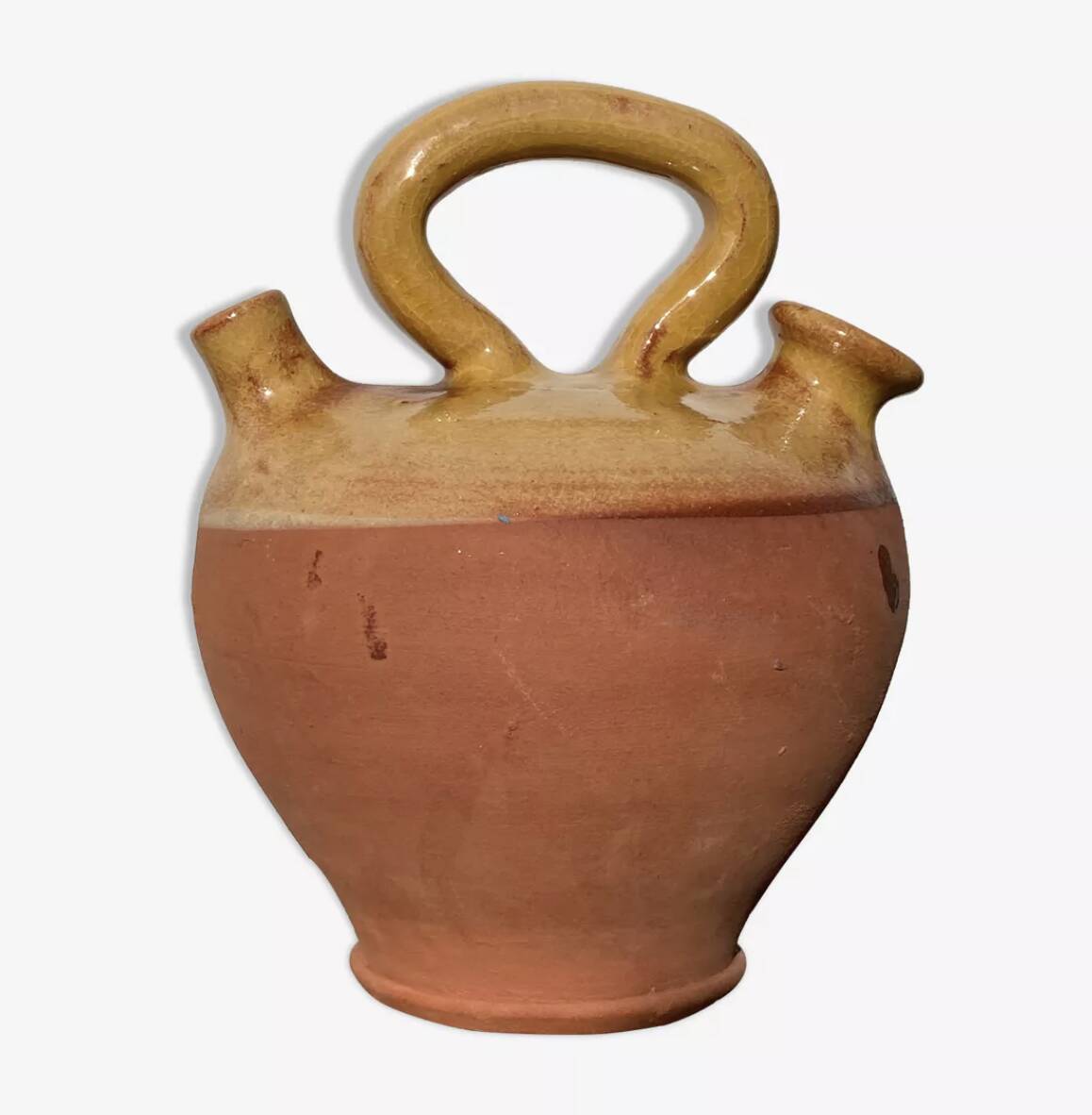 Gargoulette or old jug in yellow glazed terracotta