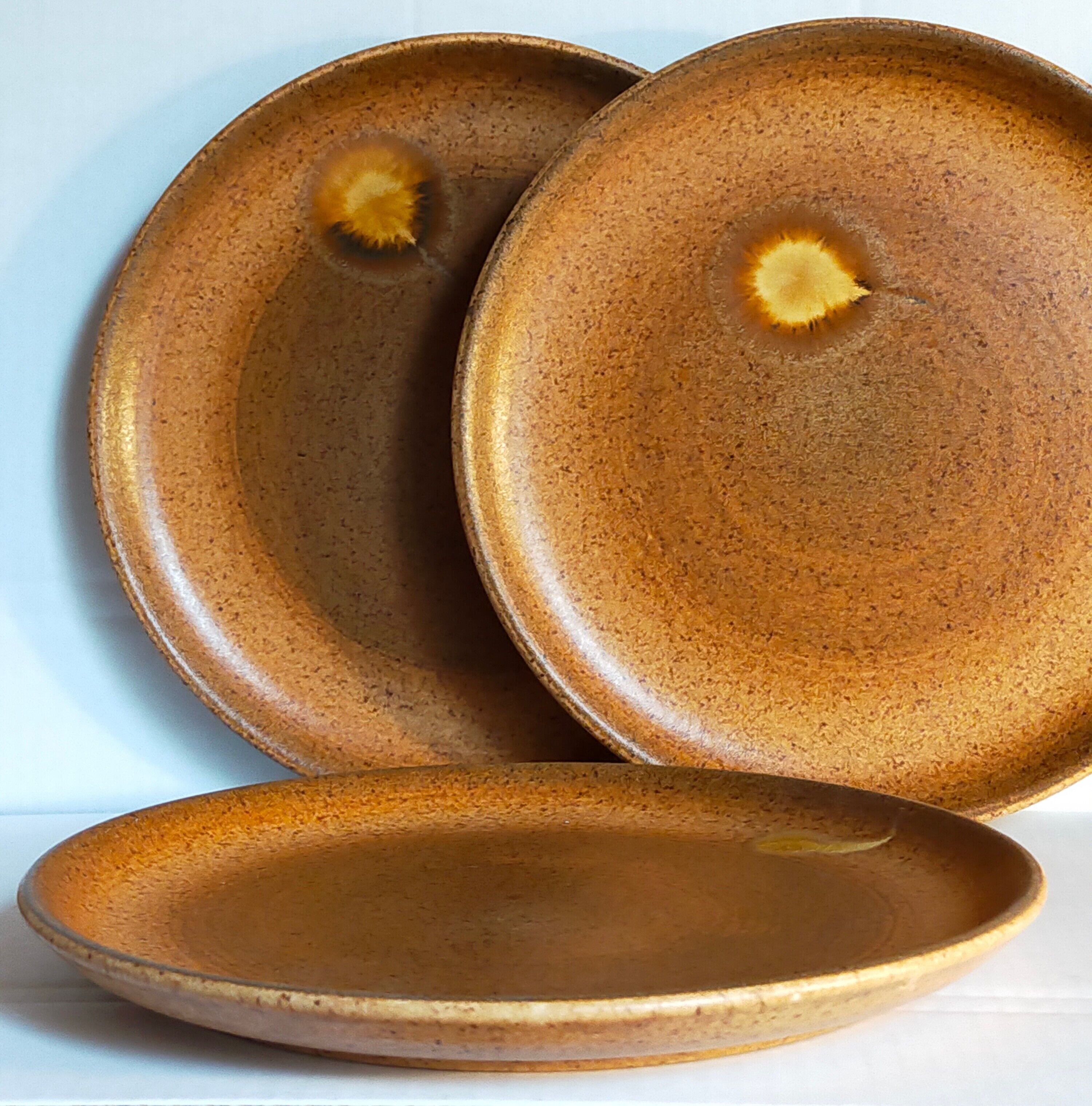 Four vintage glazed stoneware potter's plates